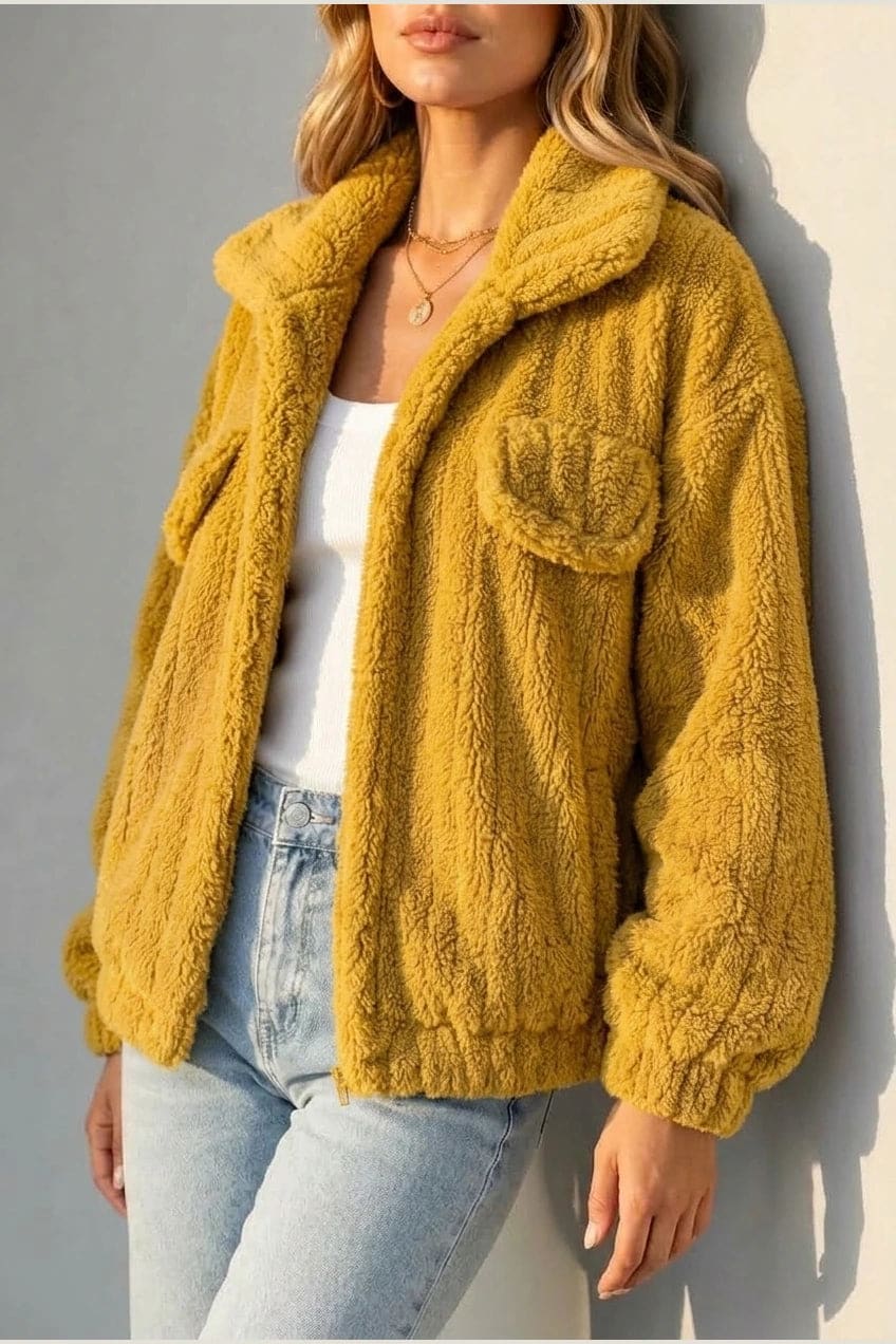 Cropped textured fleece jacket with wide collar, open front, chest flap pockets and elasticated cuffs, worn over a tank top with straight leg jeans and white trainers._9