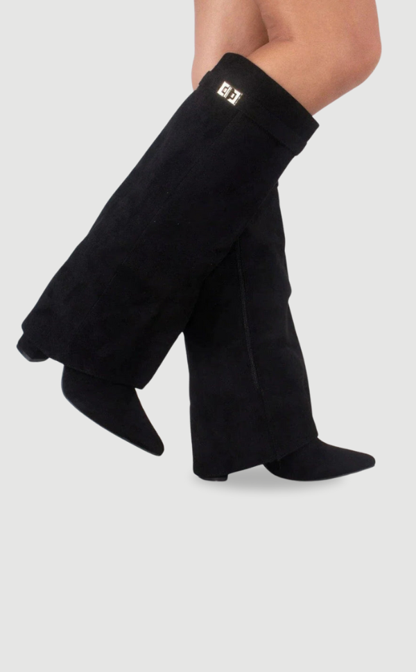 Black pointed-toe knee-high boots crossed in a dynamic side view, highlighting the wide fold-over cuff and metallic detail.
