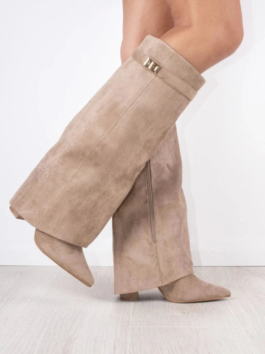 Taupe knee-high boots with pointed toes, fold-over cuffs, metallic accents, and low heels shown in a crossed side view.