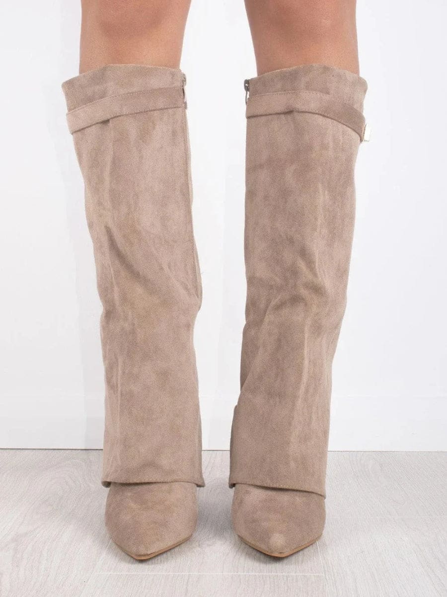 Front view of taupe knee-high boots displaying the fold-over cuffs, softly shaped shafts, pointed toes, and low heels.