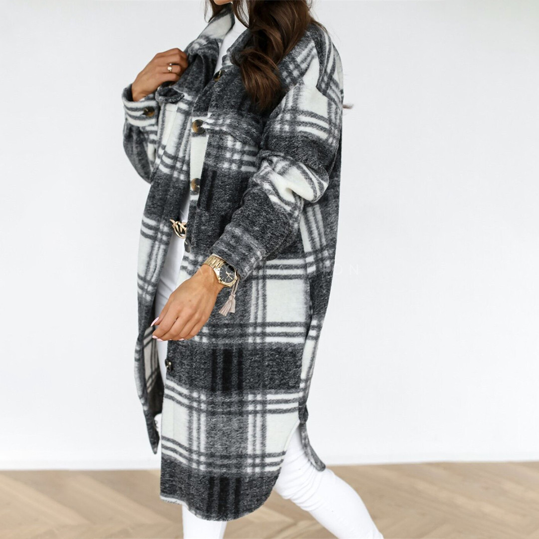 Woman wearing a long checked hooded button-front shacket with chest pockets and turnback cuffs, holding a small backpack._3