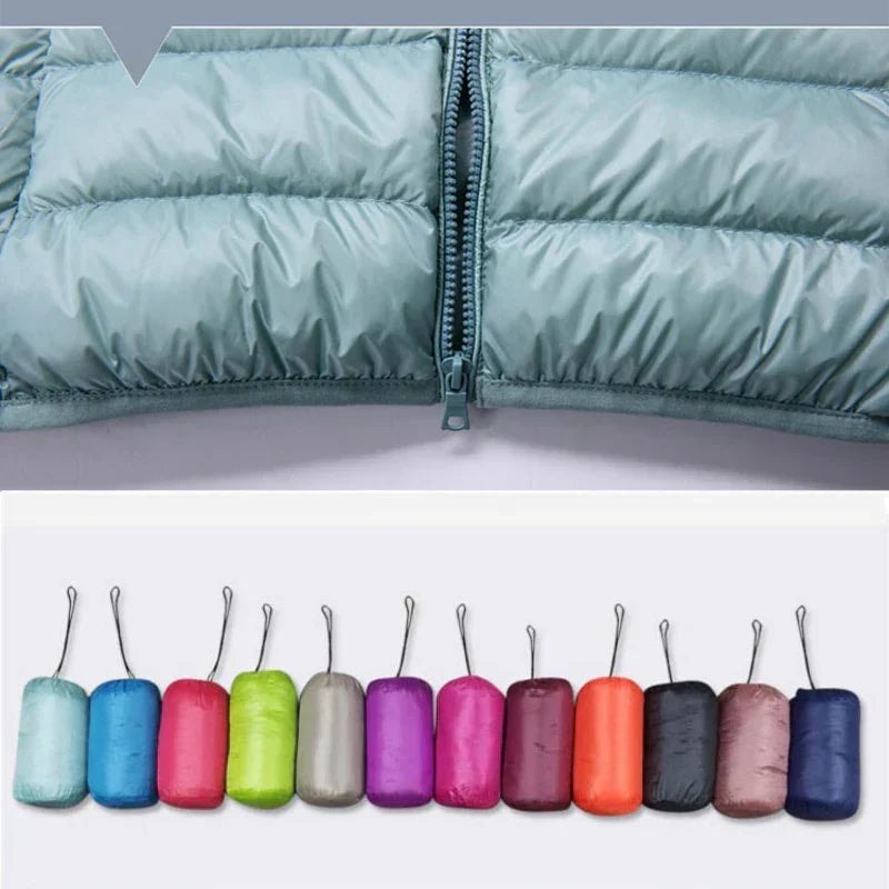 Close-up of a light blue puffer jacket zipper and quilted front, with assorted compact bundles beneath.