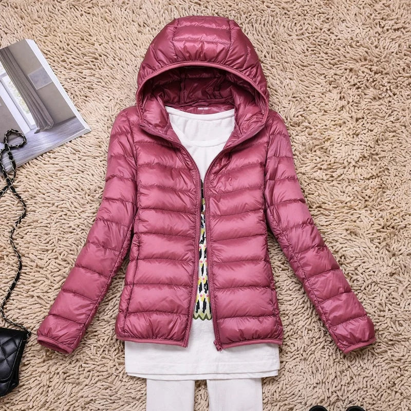 Mauve hooded quilted puffer jacket displayed open over a white outfit.