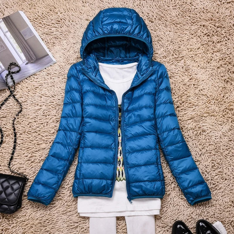 Royal blue hooded puffer jacket displayed open with long quilted sleeves.