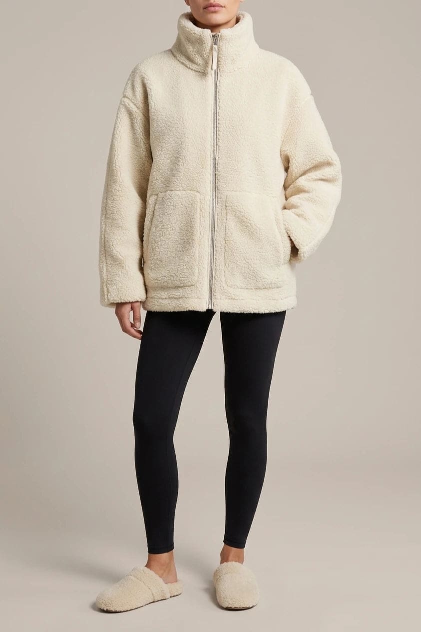 Oversized zip-up teddy fleece jacket with a high standing collar and two front patch pockets, worn with leggings._0