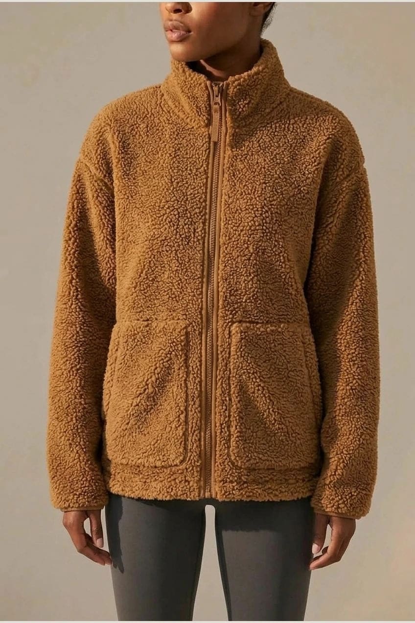 Oversized zip-up teddy fleece jacket with a high standing collar and two front patch pockets, worn with leggings._2