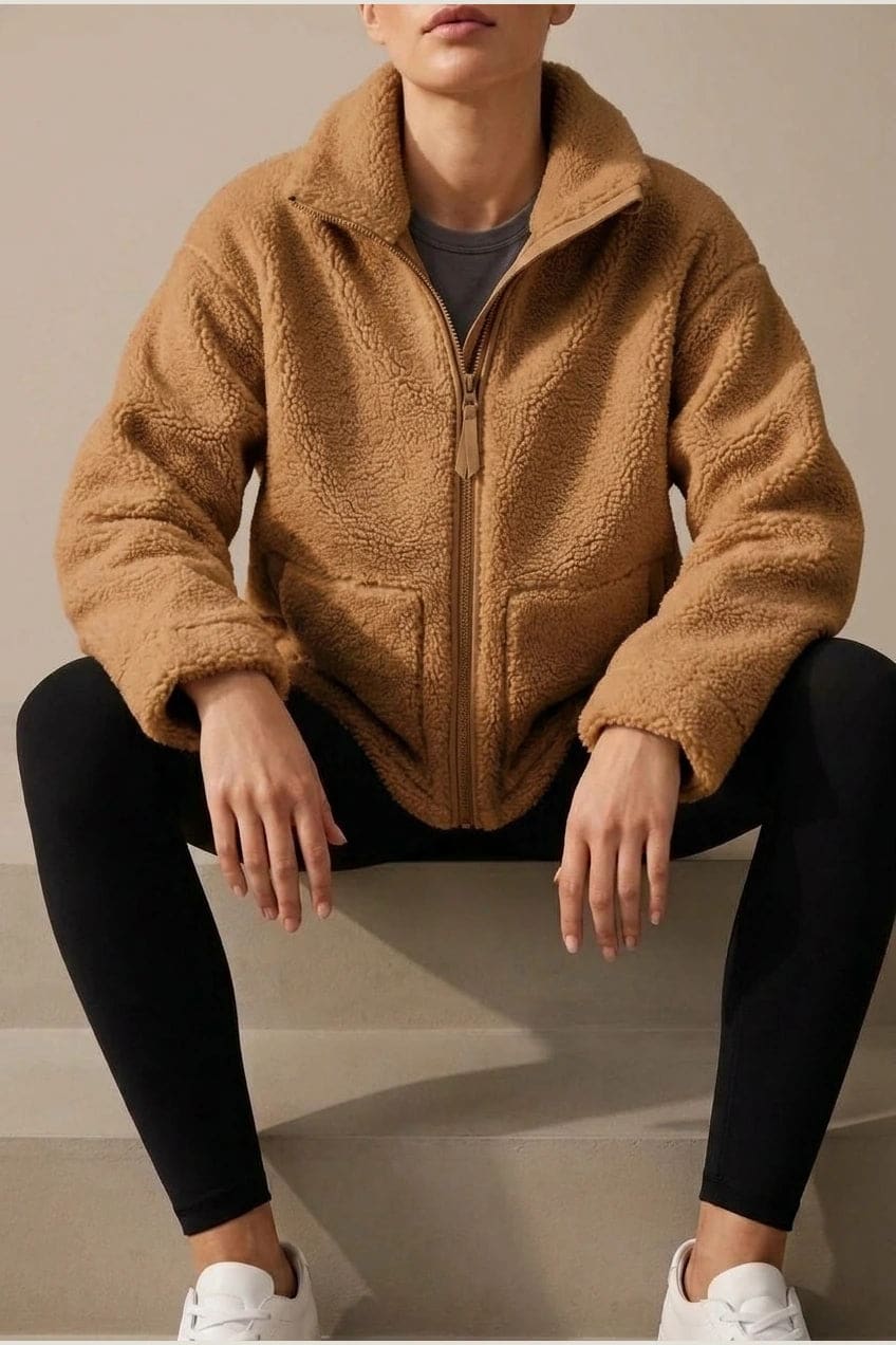 Oversized zip-up teddy fleece jacket with a high standing collar and two front patch pockets, worn with leggings._5