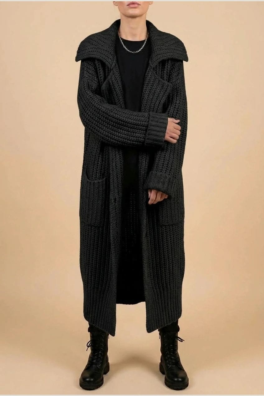 Woman wearing a long open front chunky rib knit cardigan with an oversized fold over collar, two patch pockets and ribbed cuffs, over a top and trousers with lace up boots._1