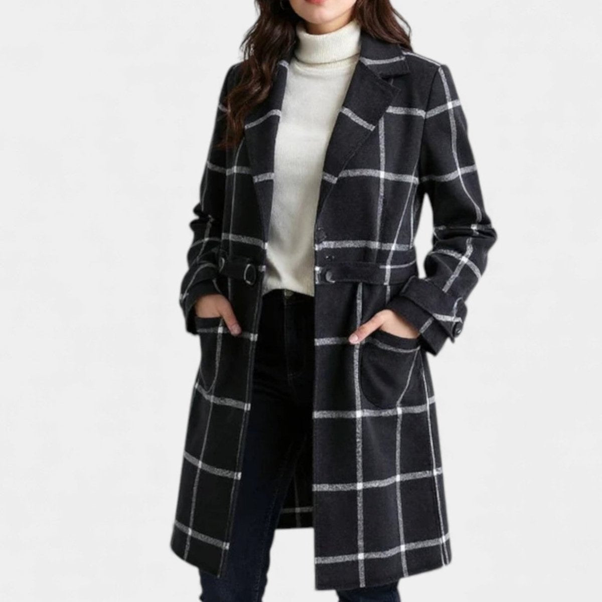 Black and white plaid coat worn over a light turtleneck, highlighting the notched lapels, long sleeves, side pockets, and single-breasted front.
