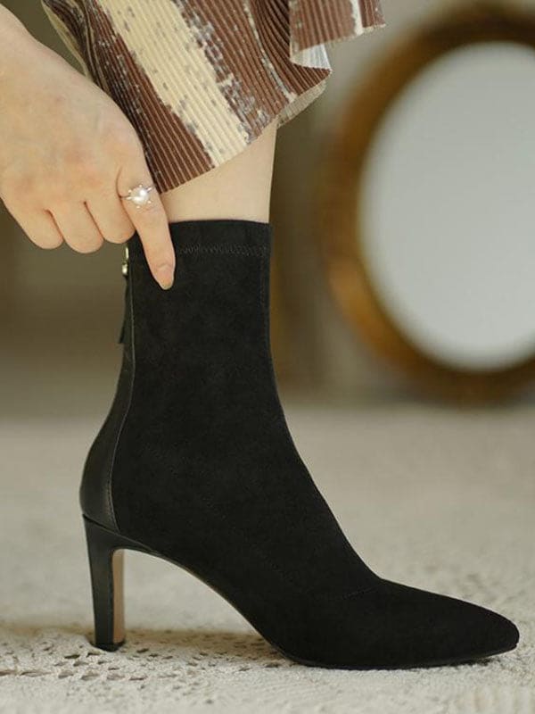 Woman wearing beige pointed toe sock boots with mid heel and back zipper, styled with cropped jeans._1