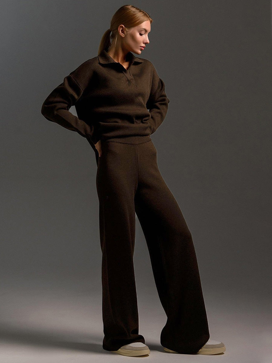 Model wearing the dark brown set with hands at the waist, showing the sweater and wide-leg silhouette.