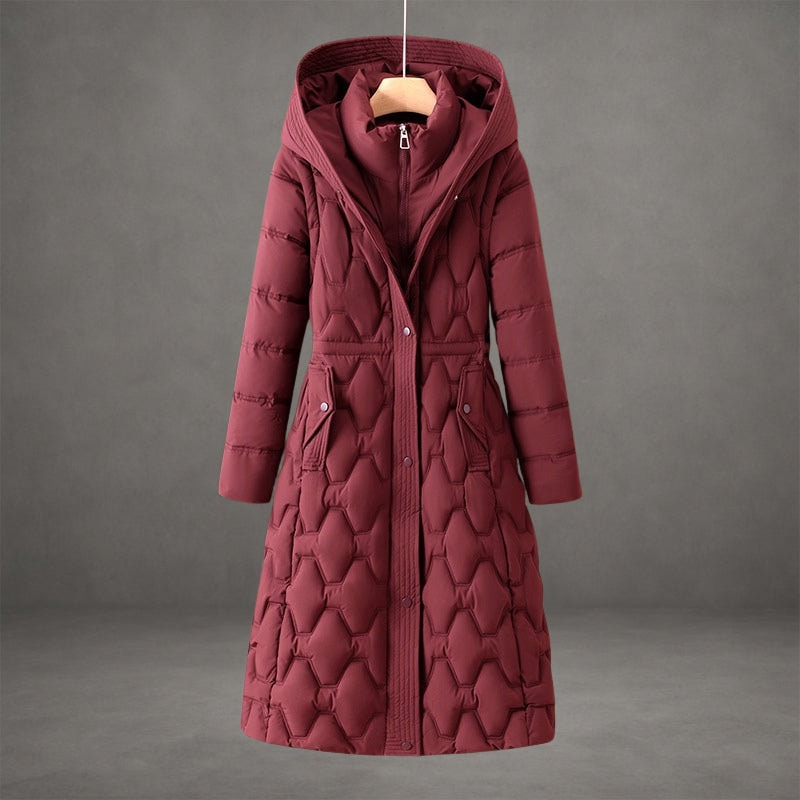Burgundy quilted hooded longline coat with a front closure, defined waist, long sleeves, and two flap pockets.