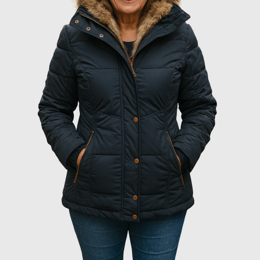 Close front view of a black quilted puffer jacket with a faux-fur-trimmed hood, front zip and snap fastening, and two zipped side pockets, worn with the hood down.