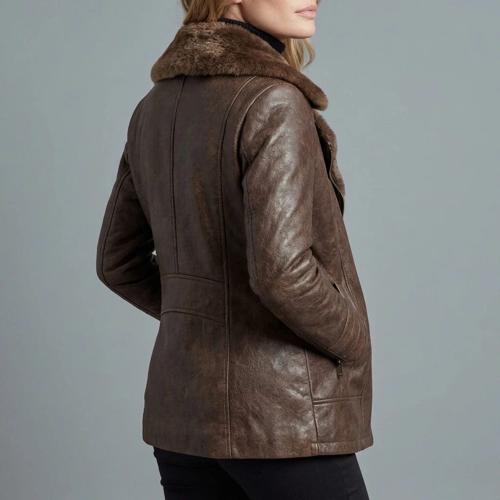 Woman viewed from behind wearing a hip-length zip-front jacket with a faux fur collar, welt pockets and ribbed sleeve detail._3