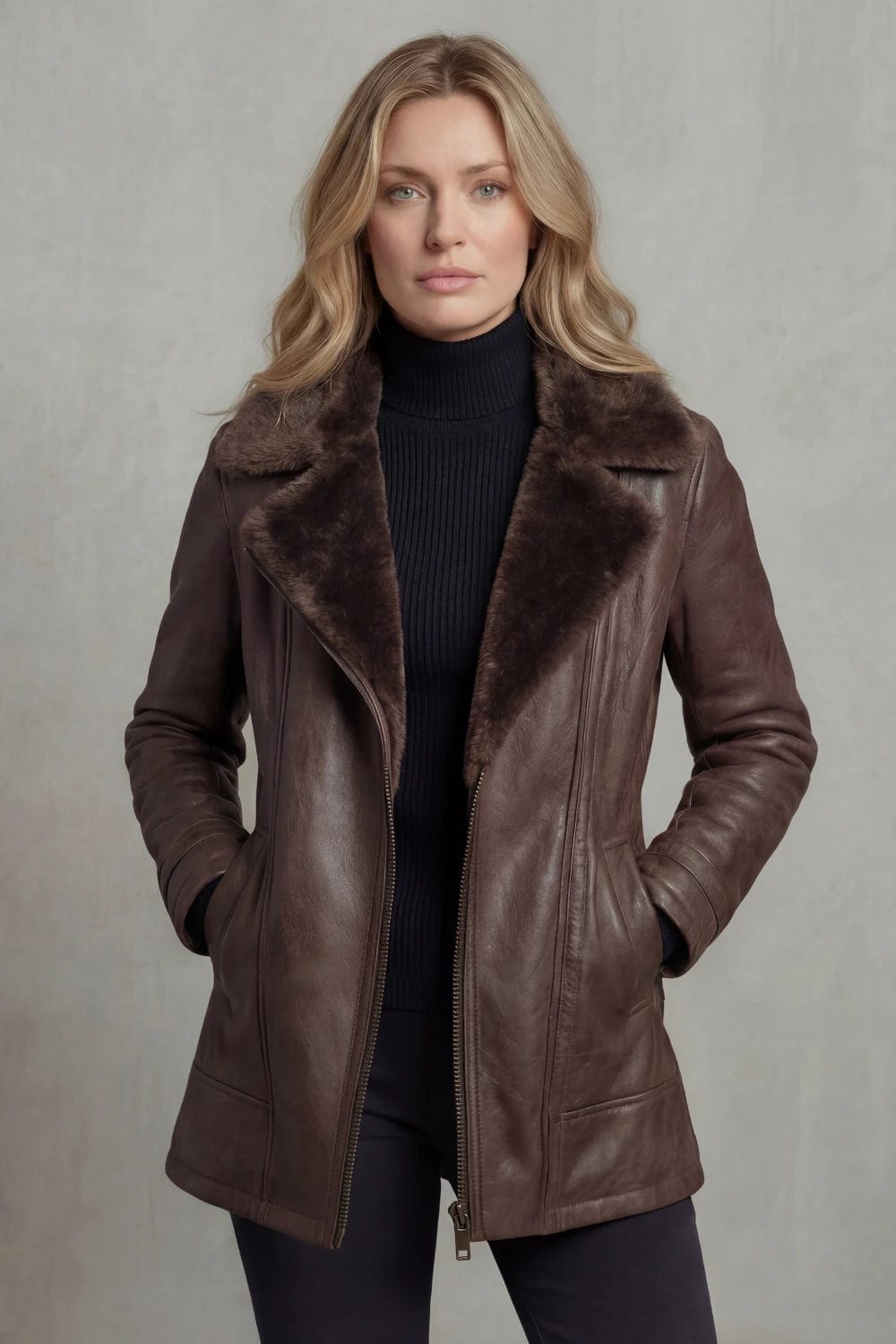 Woman viewed from behind wearing a hip-length zip-front jacket with a faux fur collar, welt pockets and ribbed sleeve detail._7