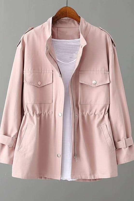 Utility style jacket with stand collar, zip and snap front, two flap chest pockets, two hip pockets, drawstring waist and tabbed cuffs, shown on a wooden hanger over a white top._0