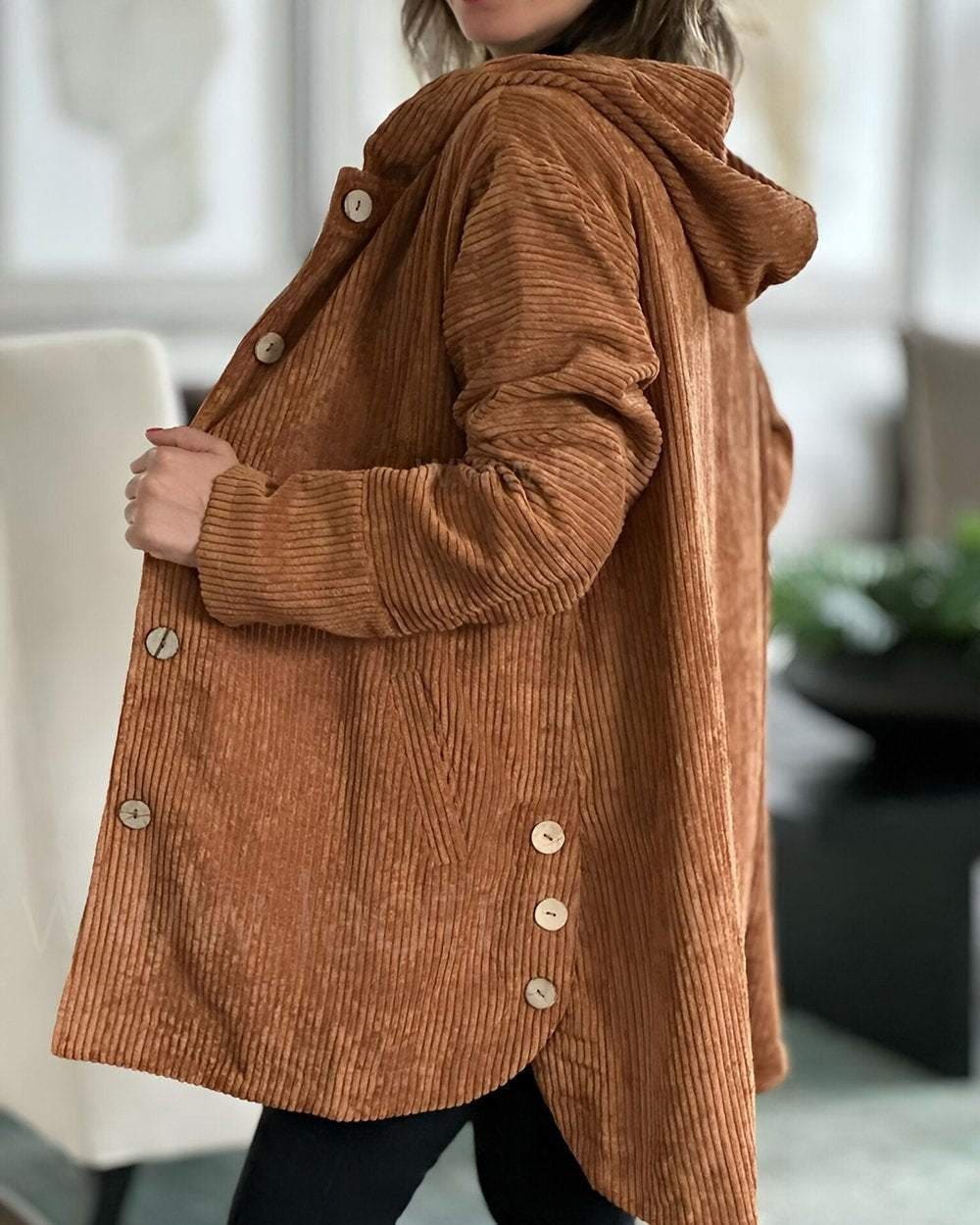 Woman wearing an open ribbed corduroy shirt jacket with four large buttons, point collar and patch pockets over a roll neck and jeans._1