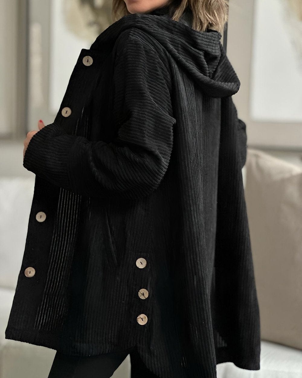 Woman wearing an open ribbed corduroy shirt jacket with four large buttons, point collar and patch pockets over a roll neck and jeans._4