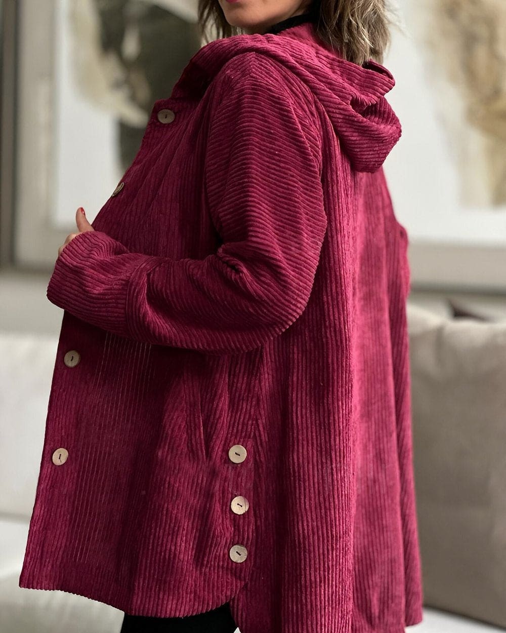 Woman wearing an open ribbed corduroy shirt jacket with four large buttons, point collar and patch pockets over a roll neck and jeans._9