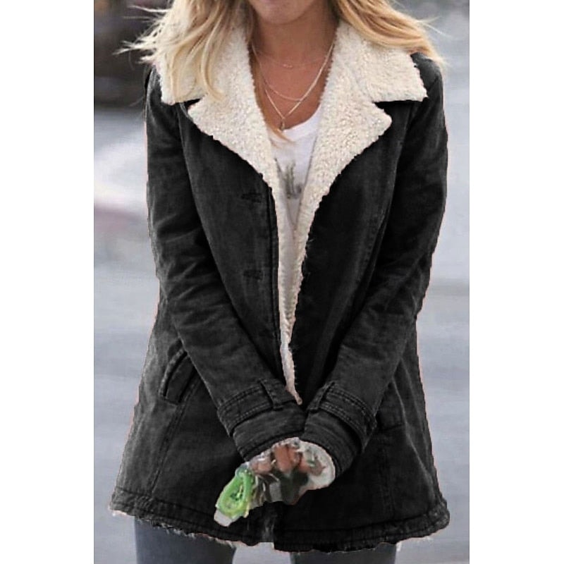 Black mid-length coat featuring a contrasting cream sherpa-lined wide notched collar and angled front pockets.