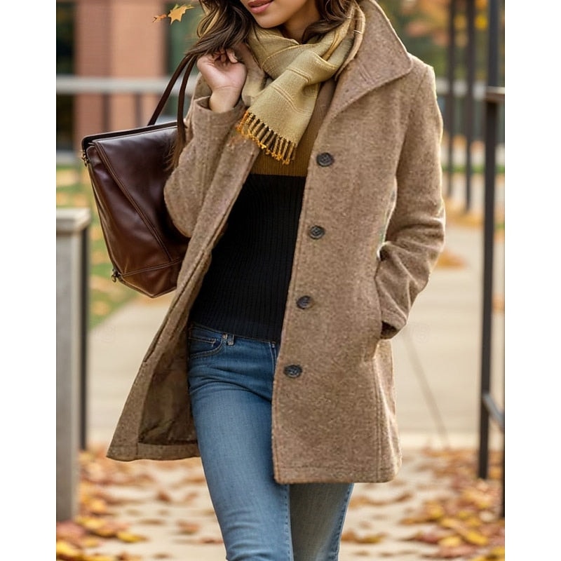 Tan women's short coat with a structured notched collar and single-breasted button closure, shown with one hand in a side pocket.