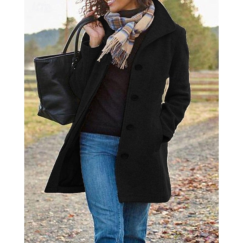 Black women's short coat with a notched collar and button closure, shown from a slightly angled view with both hands near the side pockets.