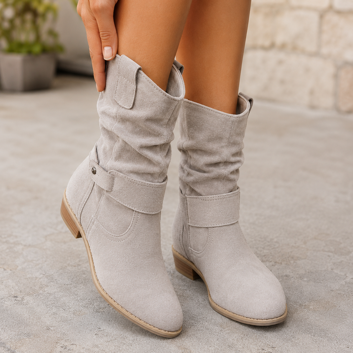 Light gray slouch mid-calf boots with rounded toes, decorative buckle ankle straps, and low block heels.