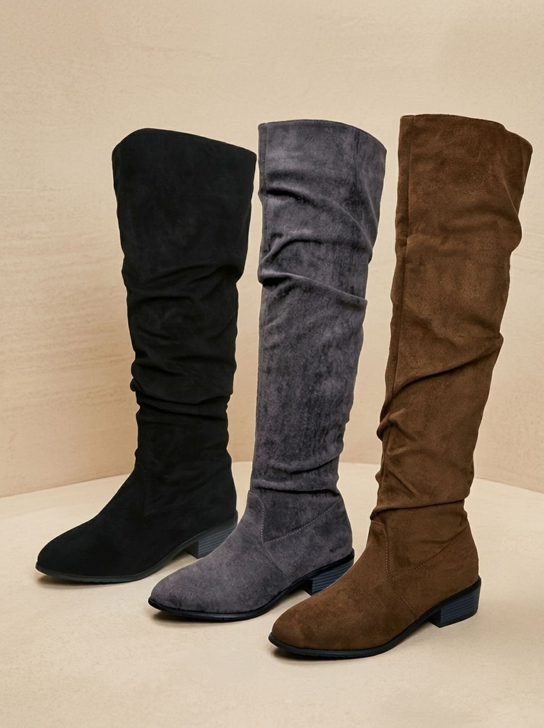 Three color options of slouchy over-the-knee boots—black, gray, and brown—displayed together.