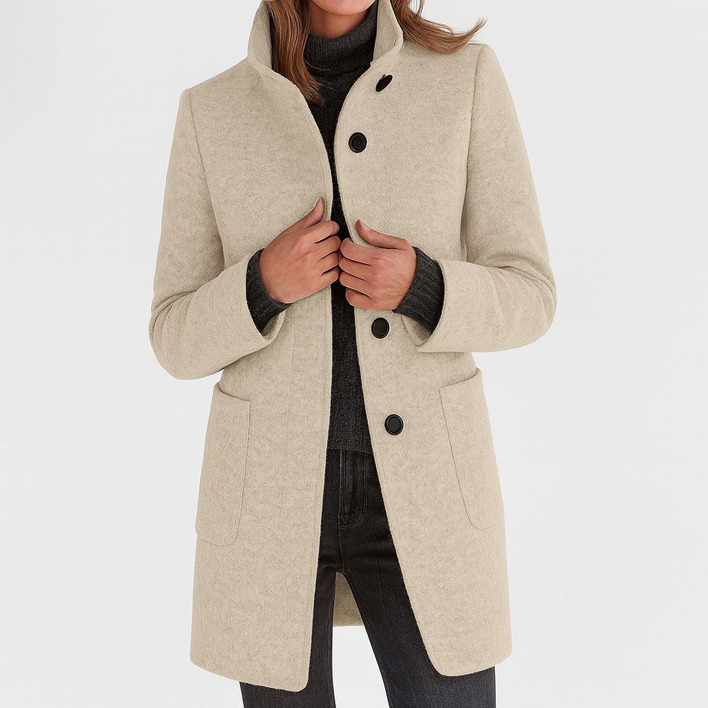 Cream-colored thigh-length women's coat with a raised collar, button-front design, long sleeves, and two lower patch pockets.