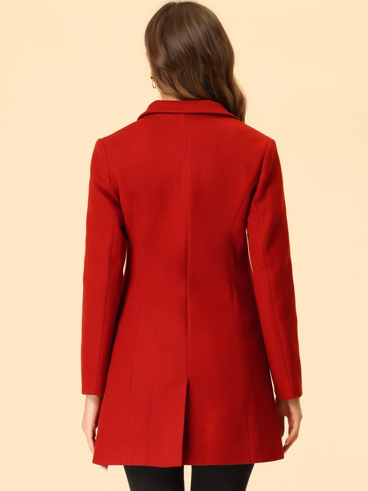 Back view of the red tailored coat, showing the center seam, long sleeves, and straight hem.