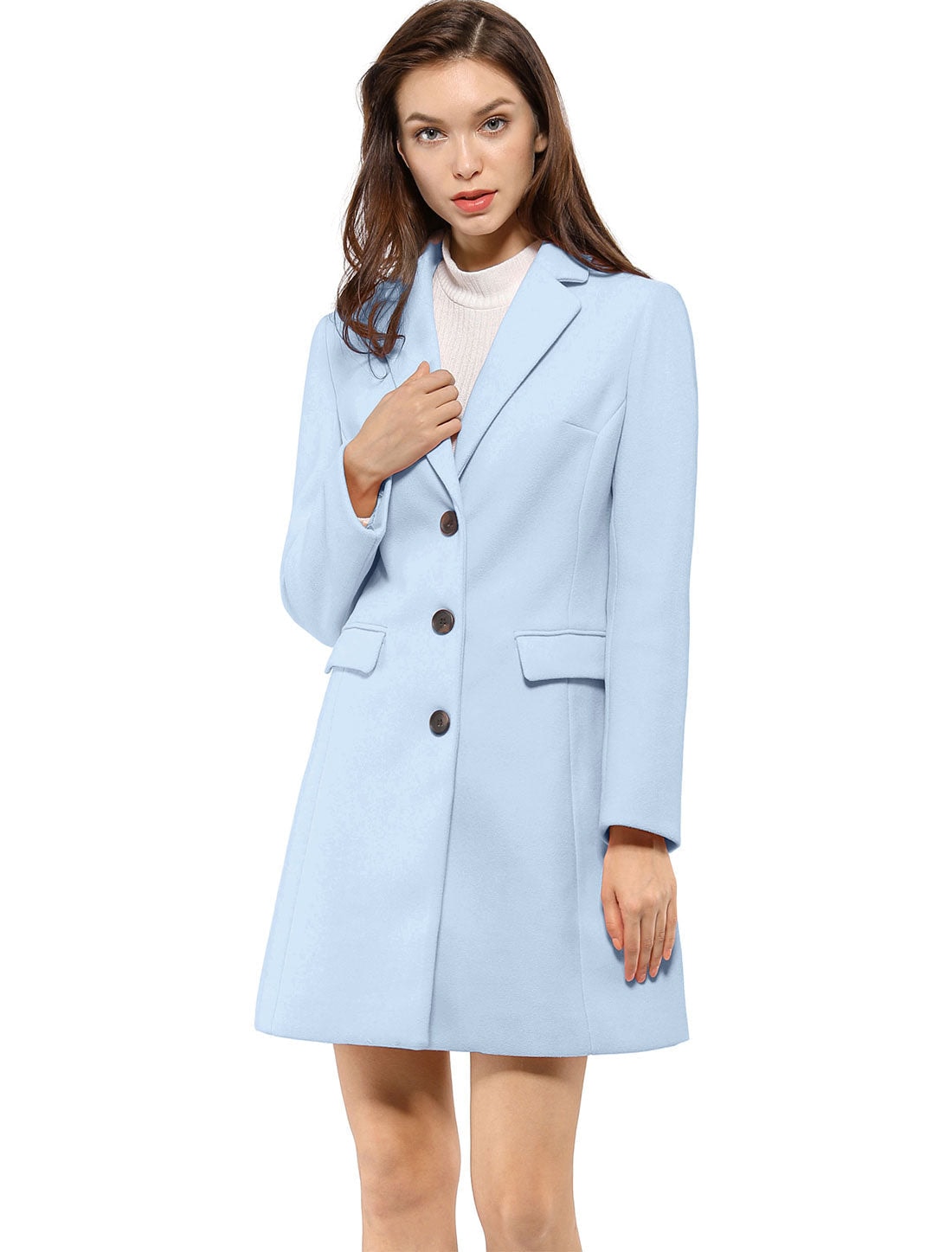 Light blue lapel coat worn closed, with the model touching one lapel and flap pockets visible.