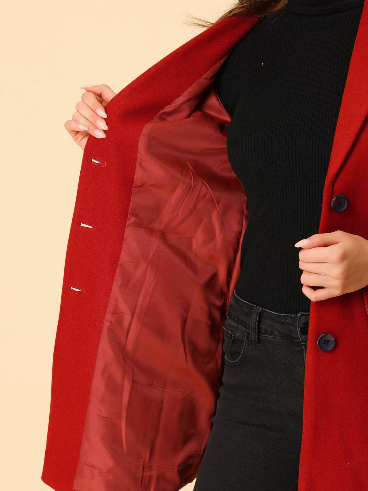 Close view of the red coat opened to reveal its smooth red interior lining, inner stitching, and button front.