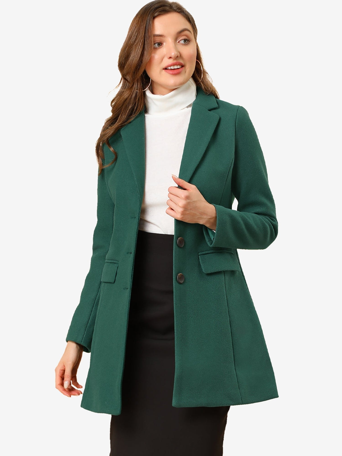 Deep green lapel coat worn over a white turtleneck and black skirt, with the front held lightly closed.