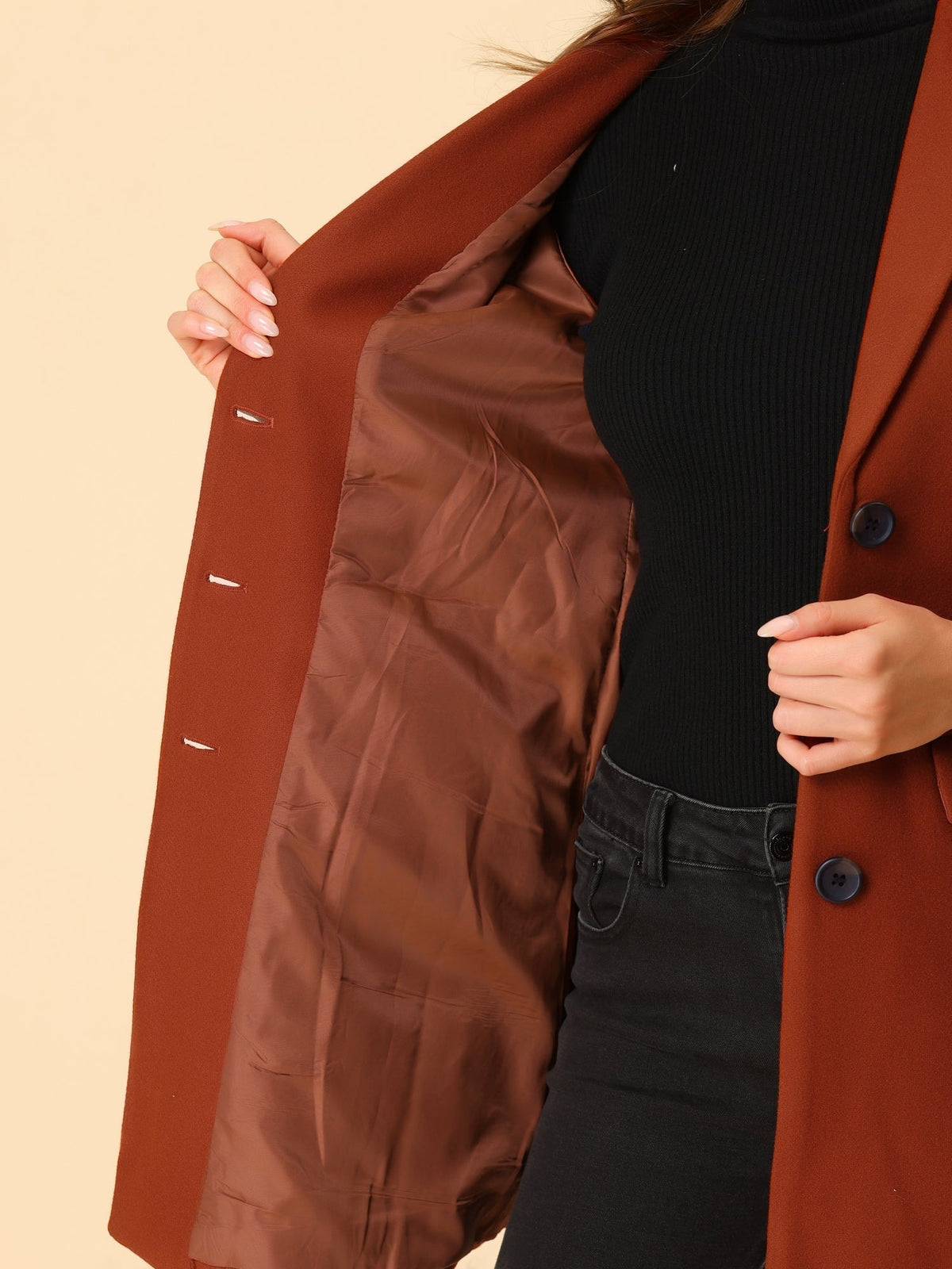 Close view of the rust-red coat opened to show its brown interior lining and inner seam details.