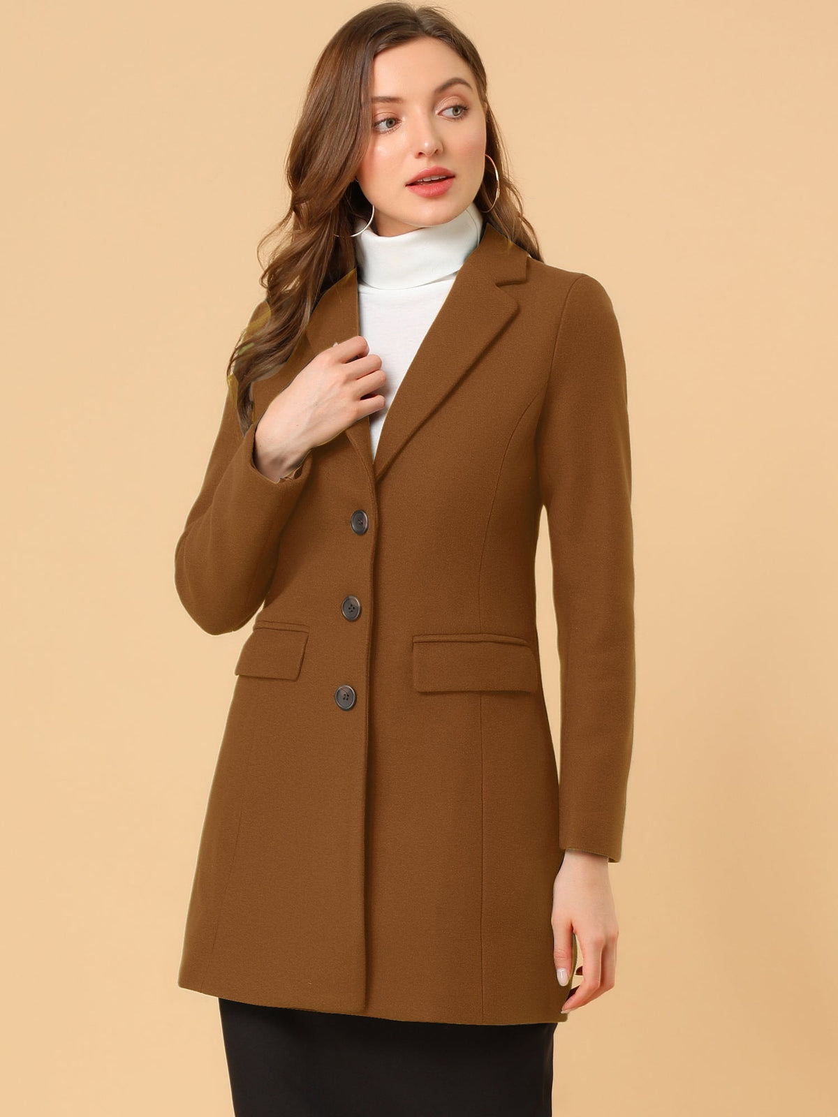 Brown tailored coat worn over a white turtleneck and black skirt, shown in a three-quarter view.