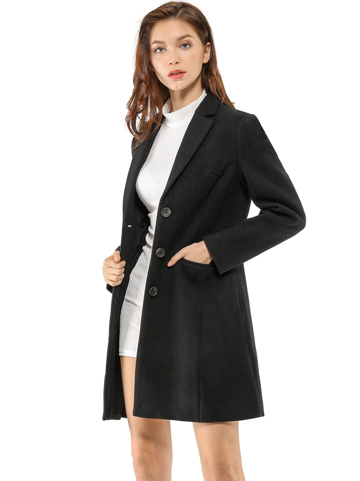 Black button-front lapel coat viewed at an angle, with one hand resting in its flap pocket.