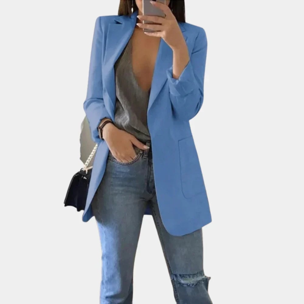 Blue tailored blazer jacket in a longline silhouette, featuring notched lapels and a visible front pocket.