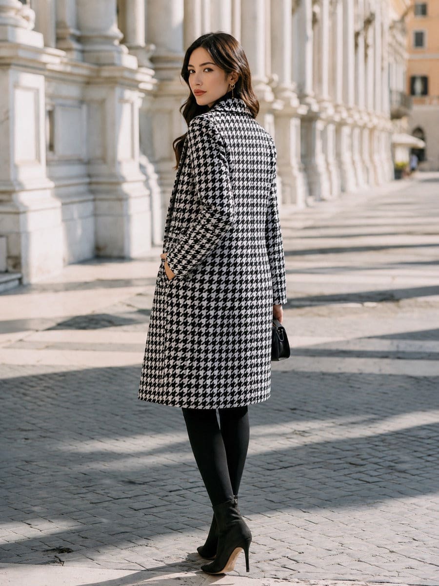 Woman wearing a long double-breasted houndstooth coat with notch lapels, worn open over a polo neck with knee-high boots._1