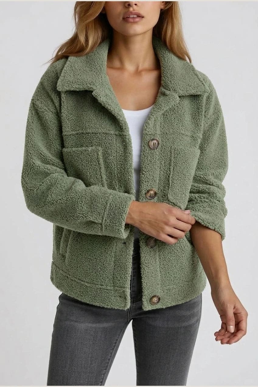 Woman wearing an open teddy-textured button-front jacket with a collar, chest pockets and lower pockets, with jeans and ankle boots._1