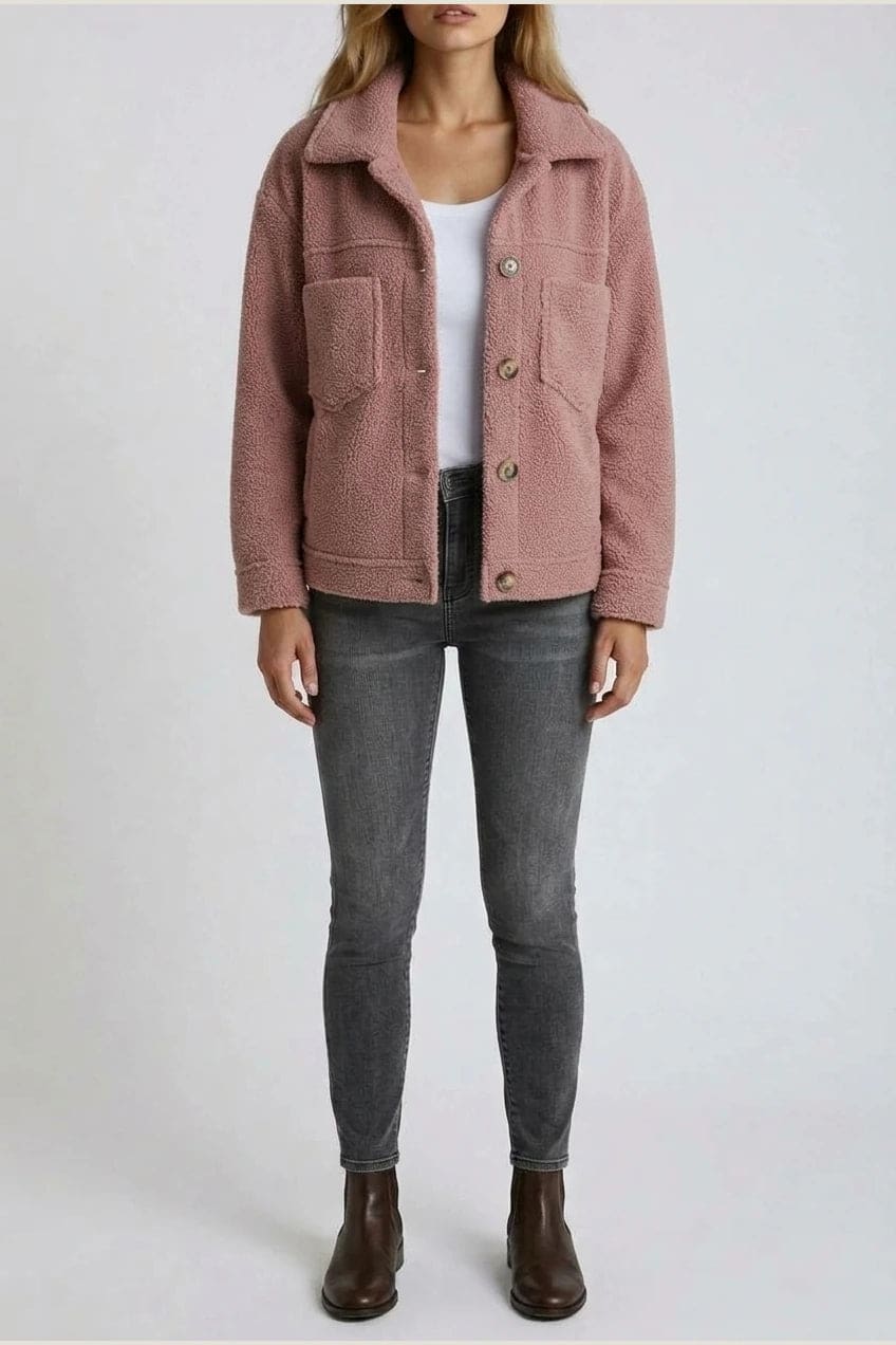 Woman wearing an open teddy-textured button-front jacket with a collar, chest pockets and lower pockets, with jeans and ankle boots._13