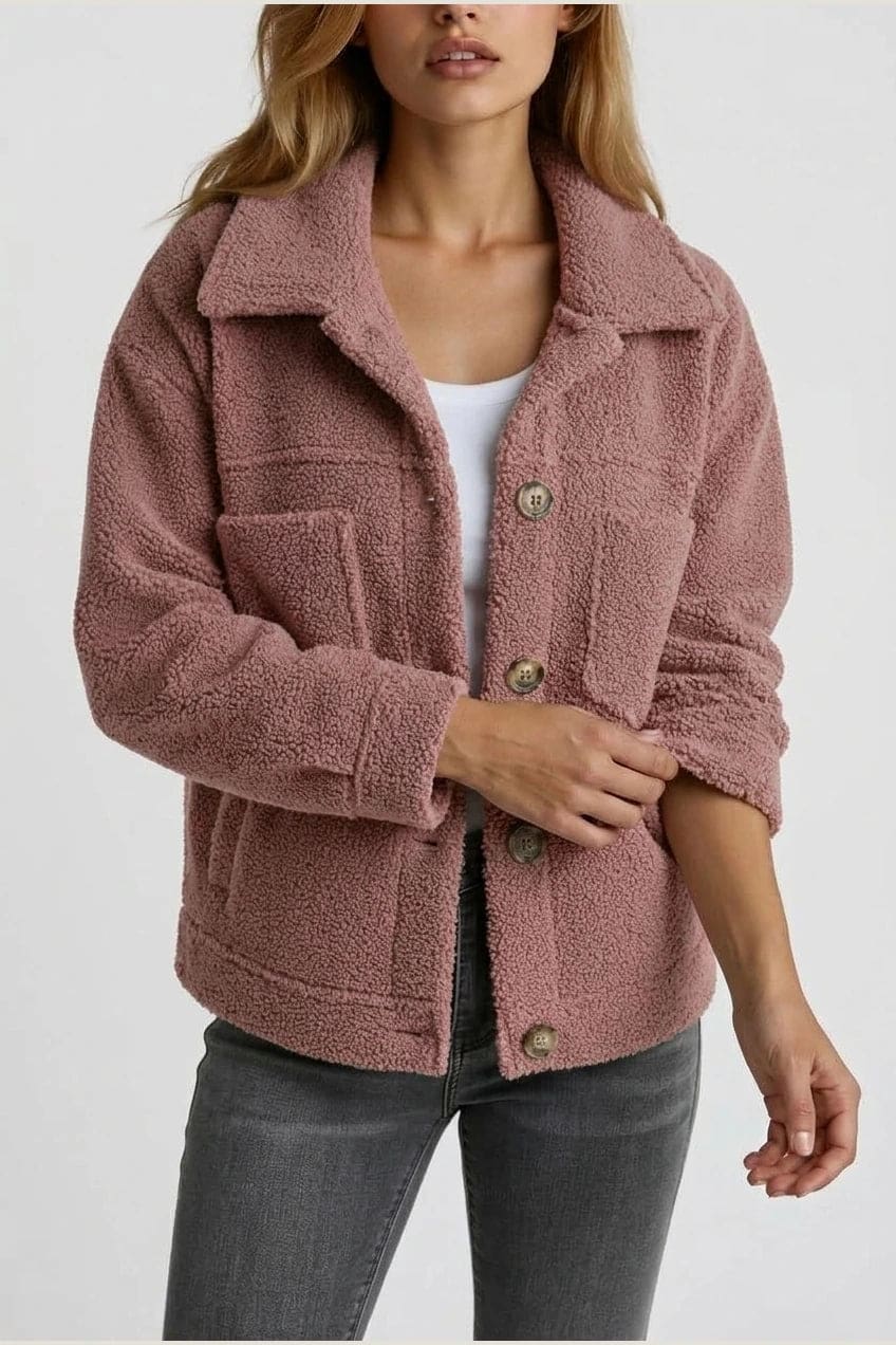 Woman wearing an open teddy-textured button-front jacket with a collar, chest pockets and lower pockets, with jeans and ankle boots._14