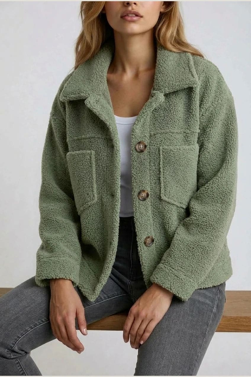 Woman wearing an open teddy-textured button-front jacket with a collar, chest pockets and lower pockets, with jeans and ankle boots._3
