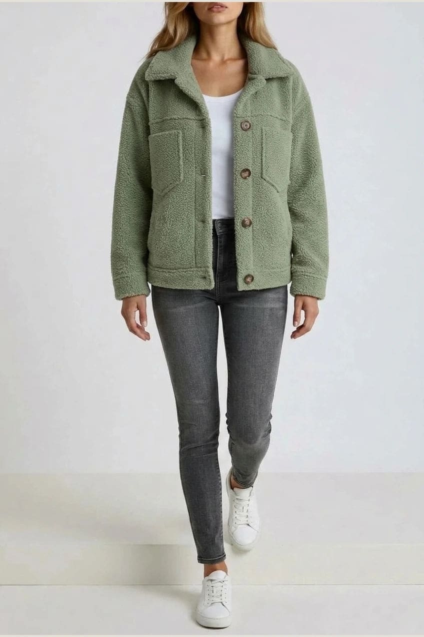 Woman wearing an open teddy-textured button-front jacket with a collar, chest pockets and lower pockets, with jeans and ankle boots._4