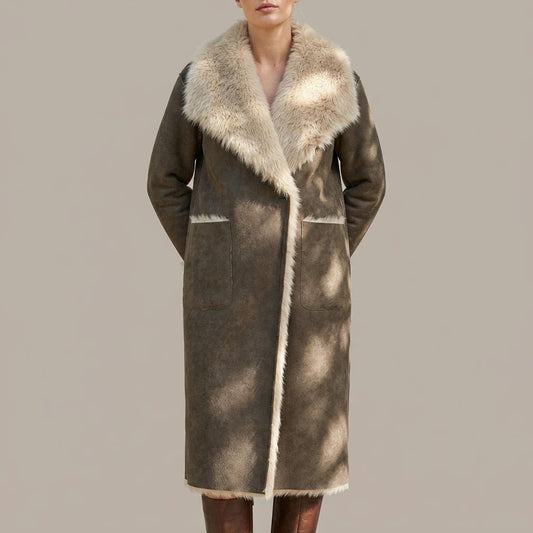 Woman wearing a long open-front coat with a large plush shawl collar, trimmed edges and two patch pockets, worn over tall boots._0