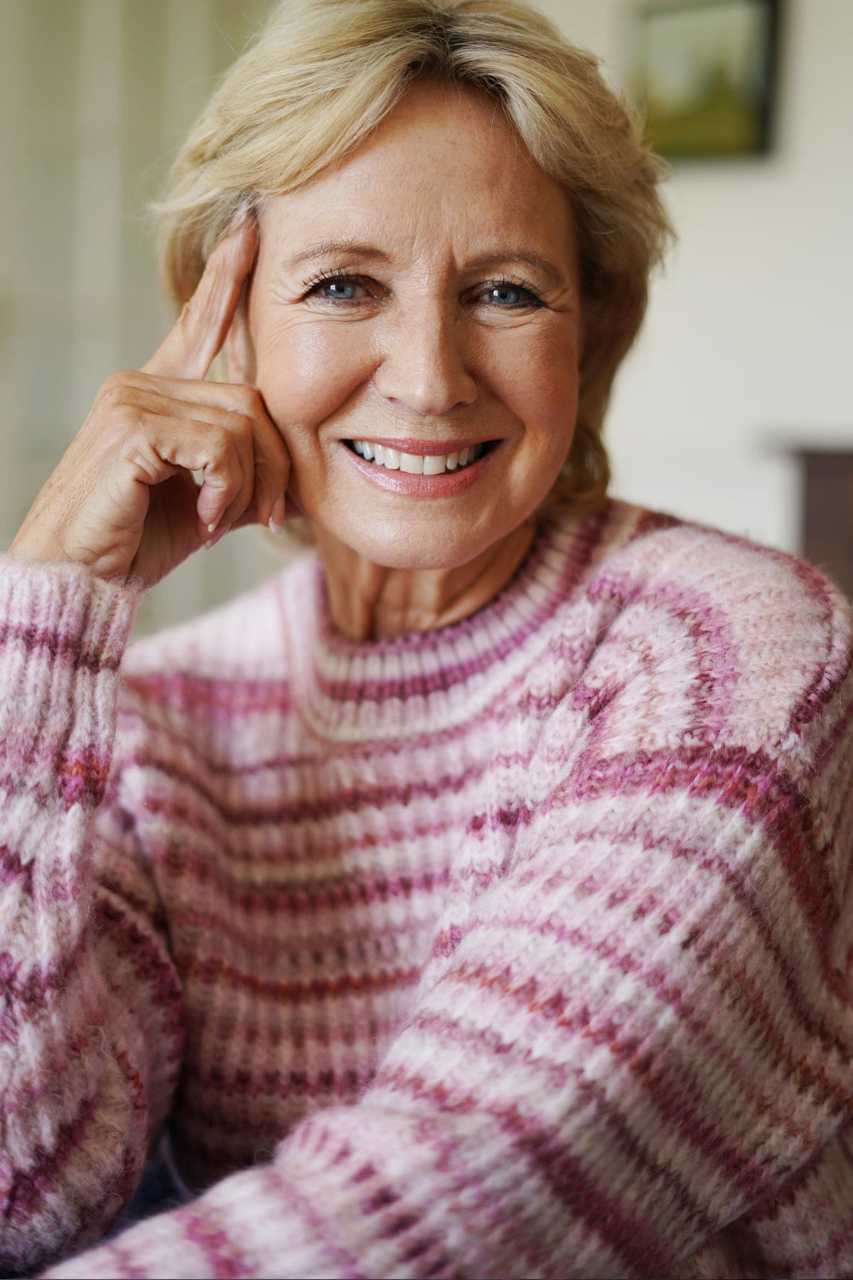 Woman sitting on a sofa wearing a striped ribbed knit crew neck jumper with long sleeves and jeans._8