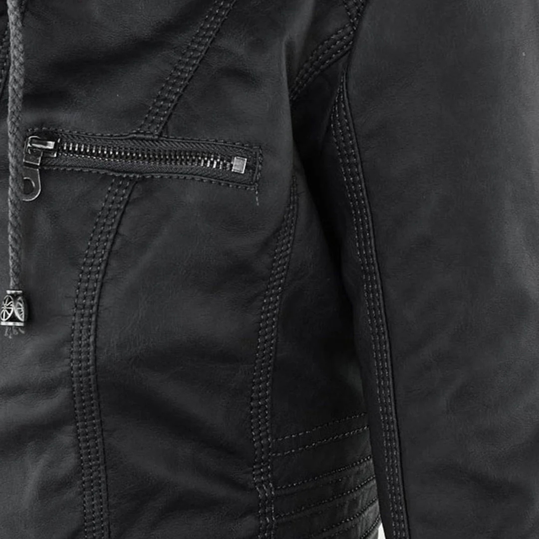Model wearing a fitted biker-style jacket with a removable hood, front zipper, and zippered pockets._9
