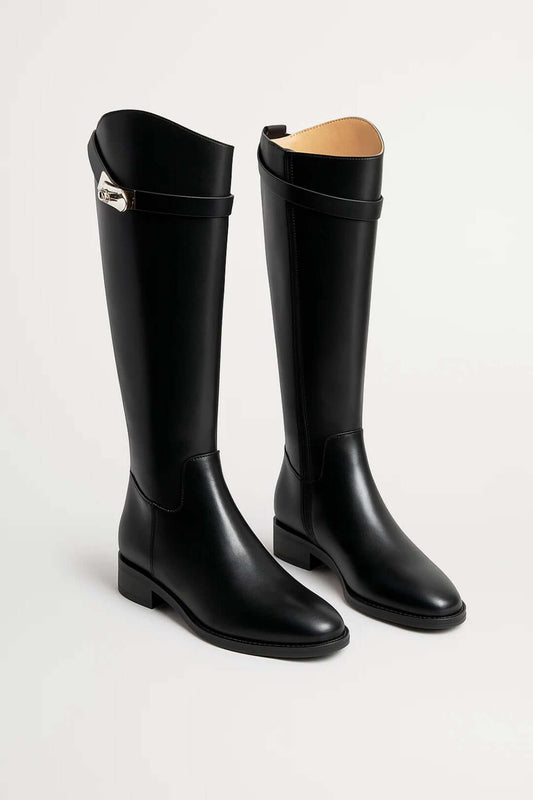 Black knee-high riding boots with low heels, smooth uppers, rounded toes, and buckle straps near the openings.