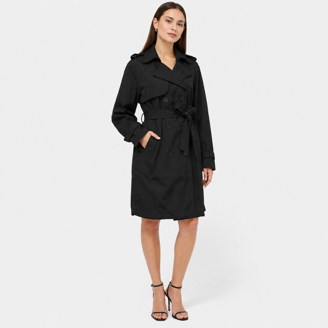 A woman wears a belted double breasted trench coat with notched lapels on a city street._2