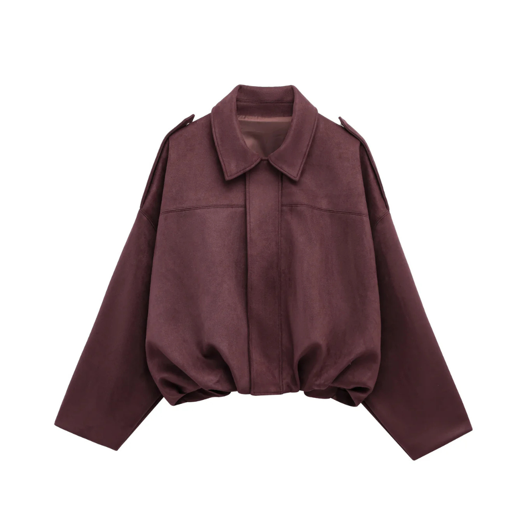 Front view of a woman wearing a relaxed bomber jacket with a pointed collar, balloon sleeves, and a gathered hem._7