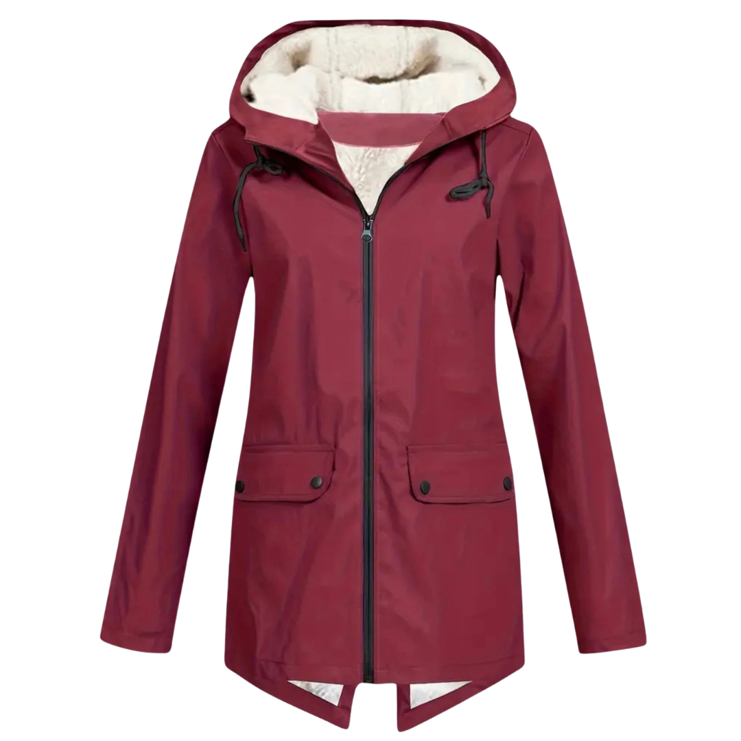 Front view of a model wearing a hooded hip-length rain jacket with a front zipper, flap pockets, and fishtail hem._12